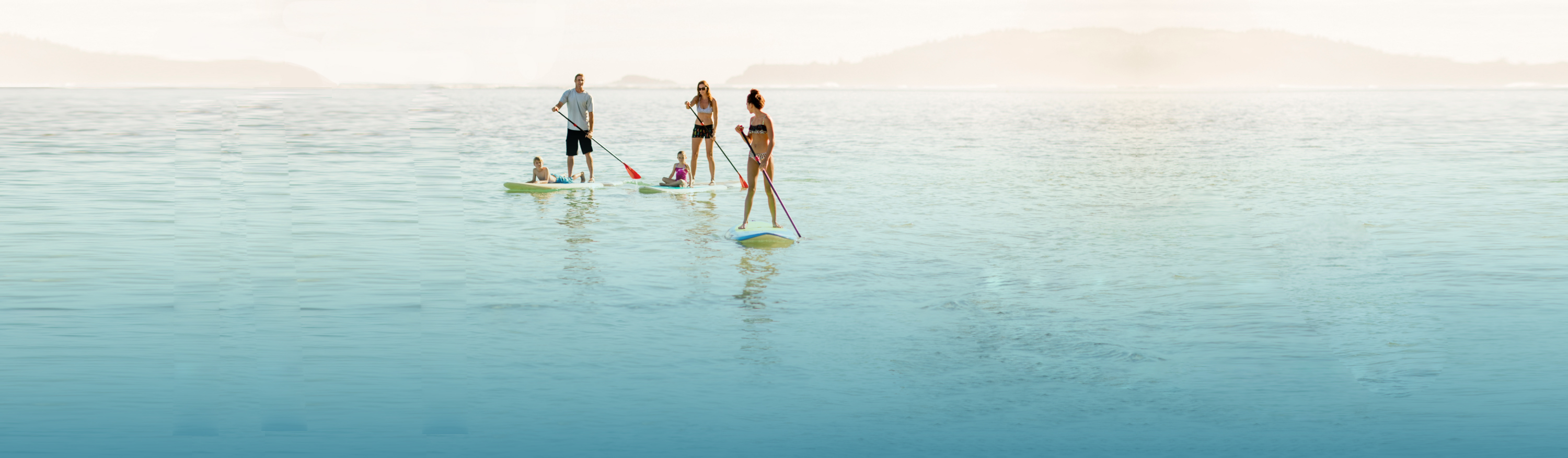 Family paddleboarding in the ocean