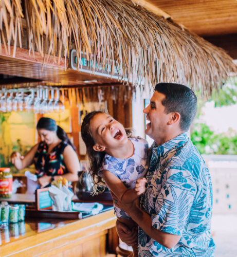 Father and daughter laughing in the restaurant