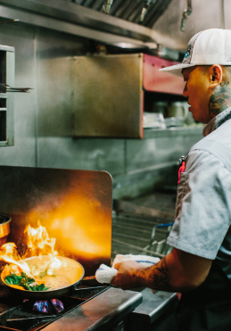 Man cooking with an open flame