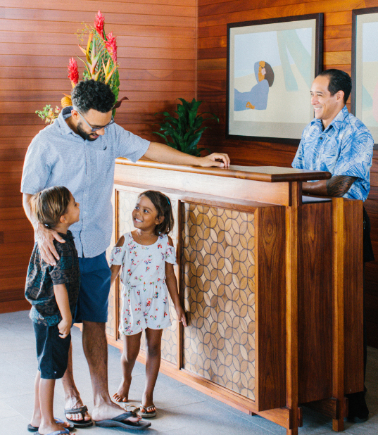 Family of three checking in with the front desk host