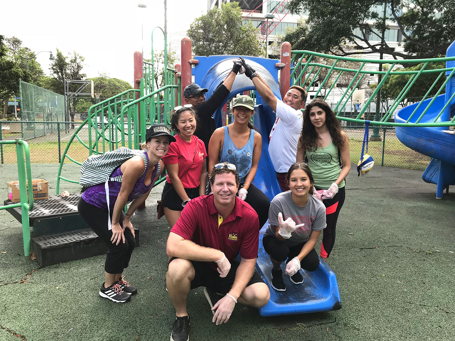 Group of people helping out at a playground outdoors