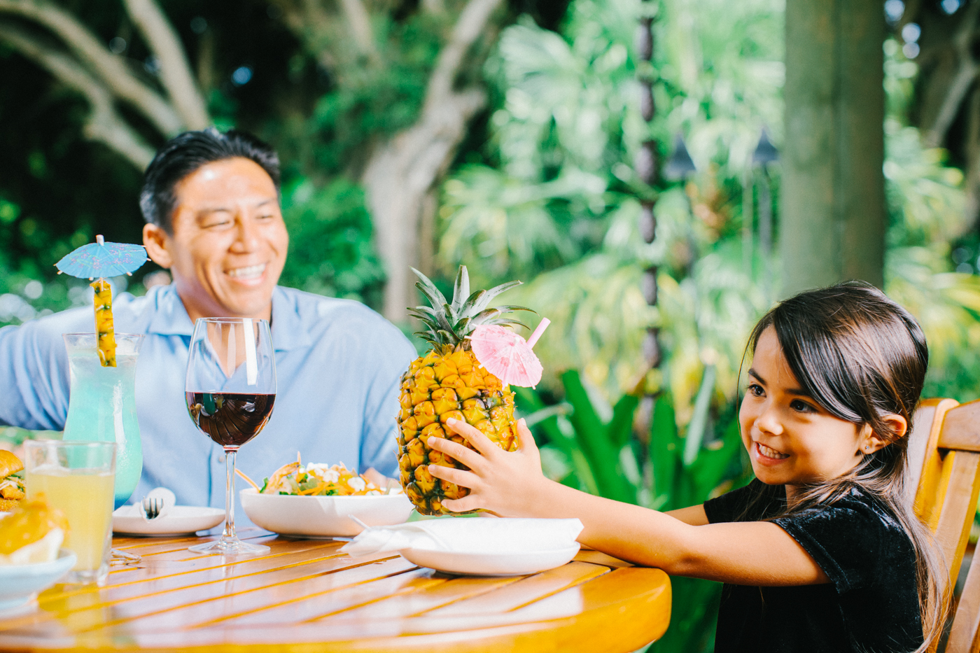 Father and Daughter with large pineapple drink