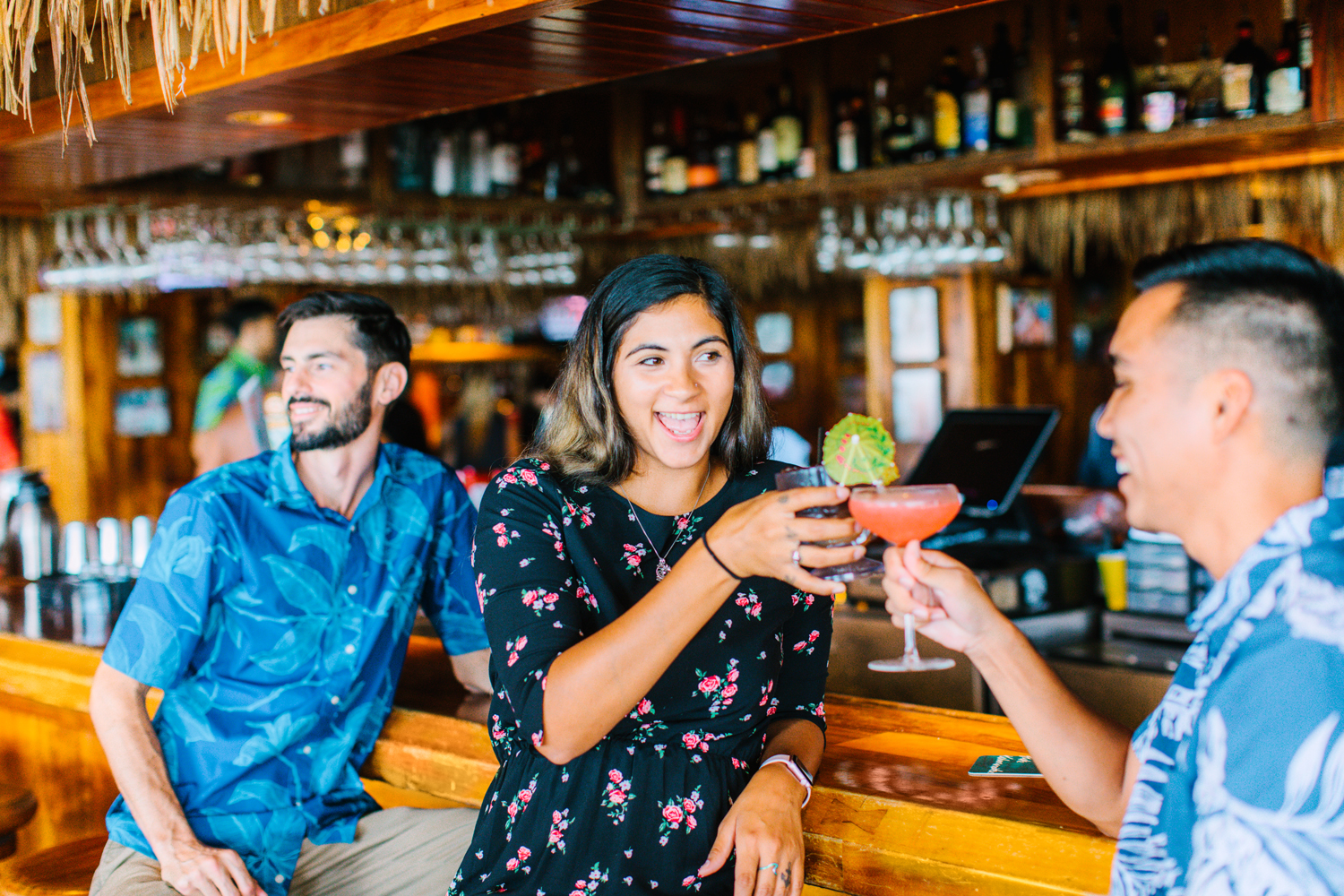 People cheers with drinks inside a bar